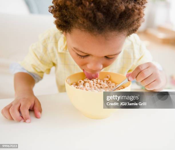 black boy eating bowl of cereal - supersensorial fotografías e imágenes de stock