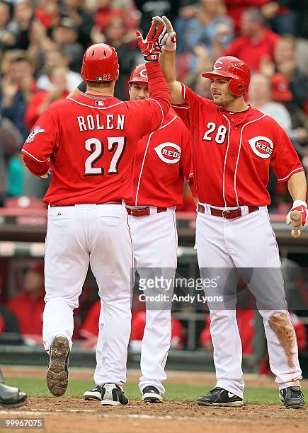 Scott Rolen of the Cincinnati Reds is congratulated by Chris Heisey after hitting a game tying two run home run in the bottom of the 9th inning...