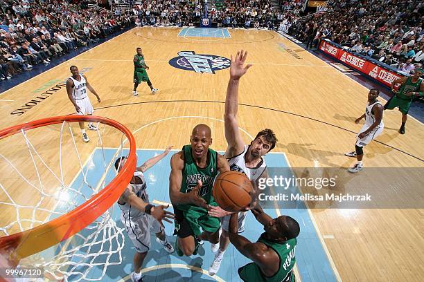 Ray Allen of the Boston Celtics lays up a shot against Mehmet Okur of the Utah Jazz during the game at EnergySolutions Arena on March 22, 2010 in...