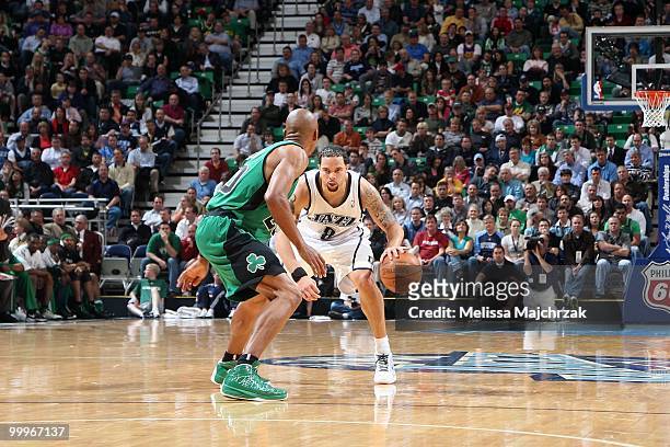 Deron Williams of the Utah Jazz moves the ball against Ray Allen of the Boston Celtics during the game at EnergySolutions Arena on March 22, 2010 in...