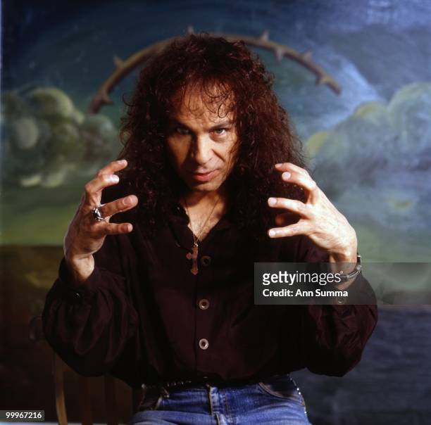 Singer Ronnie James Dio poses for a portrait in front of a painting by Manuel Ocampo on April 10, 1990 in Los Angeles, California.