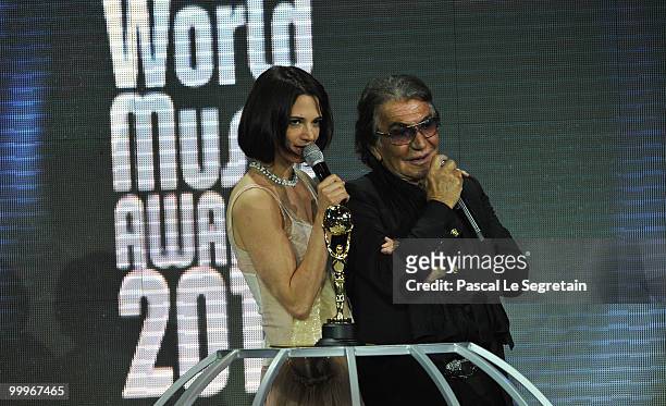 Asia Argento and designer Roberto Cavalli onstage during the World Music Awards 2010 at the Sporting Club on May 18, 2010 in Monte Carlo, Monaco.