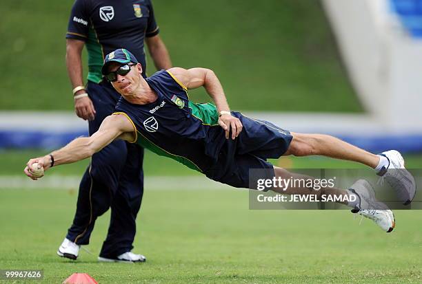 South African cricketer Mark Boucher dives to catch the ball during a practice at Sir Vivian Richards Stadium in St John's on May 18, 2010. South...
