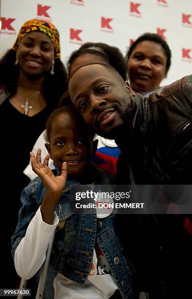 Musician Wyclef Jean greets 8-year-old Farah Maurice, who lost her leg above the knee as a result of the earthquake and who is visiting the US to...