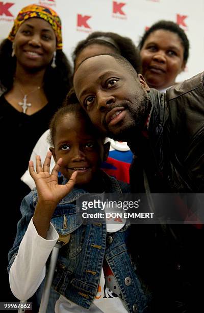 Musician Wyclef Jean greets 8-year-old Farah Maurice, who lost her leg above the knee as a result of the earthquake and who is visiting the US to...