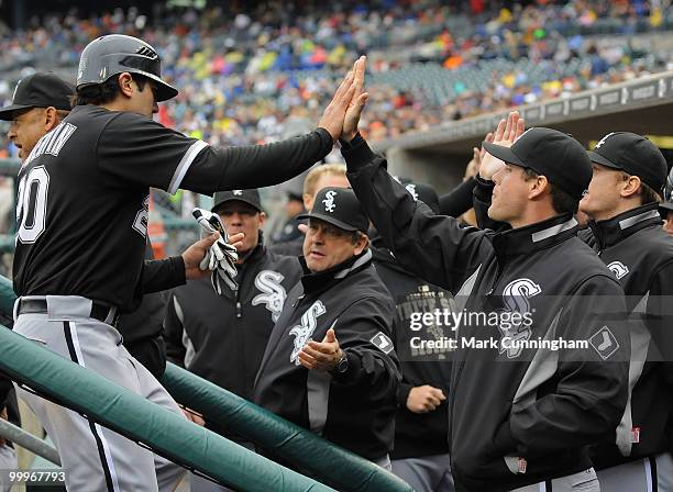 Carlos Quentin of the Chicago White Sox is congradulated by teammates after scoring in the fourth inning on a double by teammate Juan Pierre during...