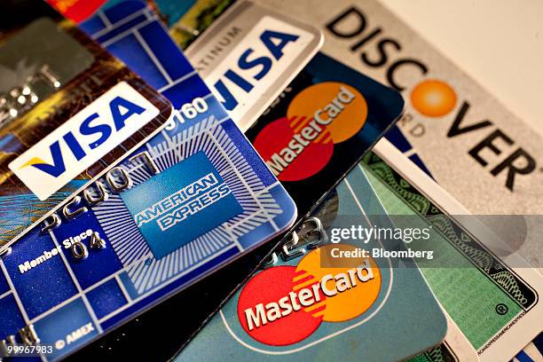 American Express, Discover, MasterCard and Visa credit cards are displayed for a photograph in New York, U.S., on Tuesday, May 18, 2010. Credit-card...