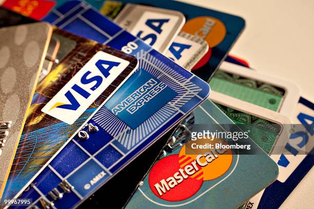 American Express, MasterCard and Visa credit cards are displayed for a photograph in New York, U.S., on Tuesday, May 18, 2010. Credit-card firms...