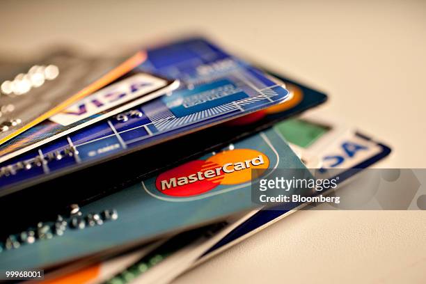 American Express, MasterCard and Visa credit cards are displayed for a photograph in New York, U.S., on Tuesday, May 18, 2010. Credit-card firms...