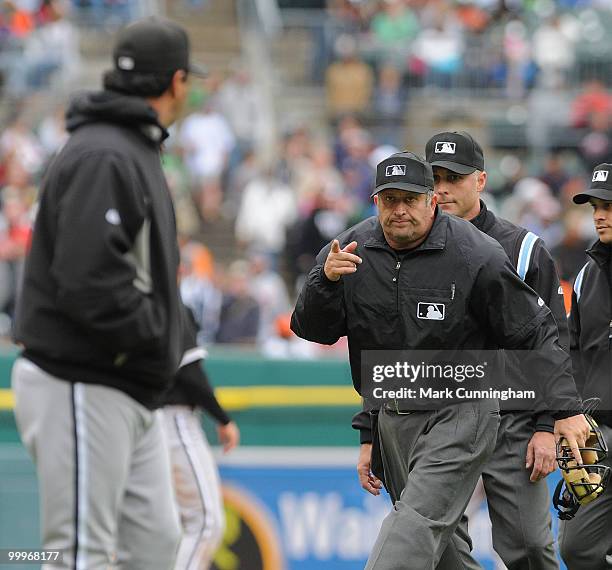 Home plate umpire Dale Scott motions to manager Ozzie Guillen of the Chicago White Sox that he will review a disputed home run by Brandon Inge of the...