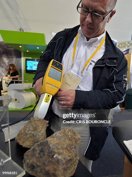 Man holds an x-ray emitting devise that analyzes metallic components in rock samples during the IX International Gold Symposium on May 18, 2010 in...