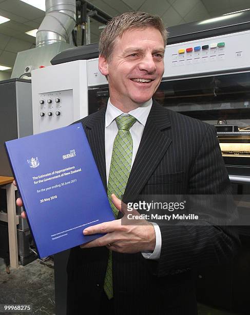 New Zealand Minister of Finance Bill English holds a copy of the budget during a visit to Printlink to oversee the printing of the Budget at Petone...