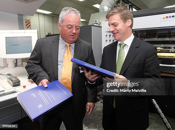 Manager of Printlink Peter Ward and New Zealand Minister of Finance Bill English hold a copy of the budget during a visit to Printlink to oversee the...