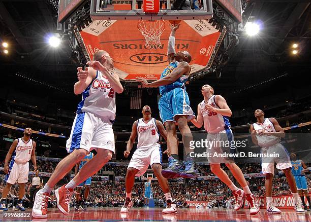David West of the New Orleans Hornets puts the shot up against Chris Kaman and DeAndre Jordan of the Los Angeles Clippers during the game at Staples...