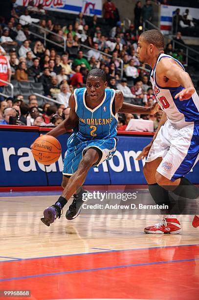 Darren Collison of the New Orleans Hornets drives the ball against Eric Gordon of the Los Angeles Clippers during the game at Staples Center on March...