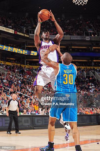 Amar'e Stoudemire of the Phoenix Suns puts a shot up against David West of the New Orleans Hornets in an NBA Game played on March 14, 2010 at U.S....