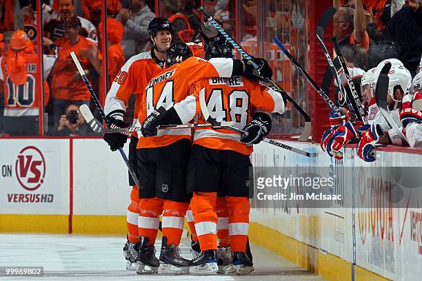 Danny Briere of the Philadelphia Flyers celebrates with his teammates Chris Pronger and Kimmo Timonen after scoring a goal in the first period...