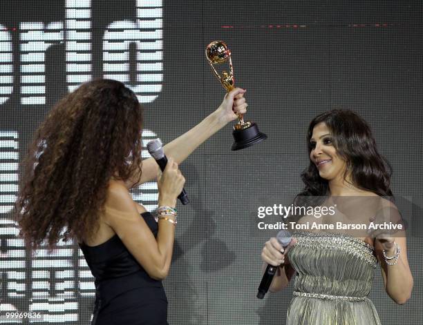 Singer Elissa receives World Music Award from Afef Jnifen on stage during the World Music Awards 2010 at the Sporting Club on May 18, 2010 in Monte...