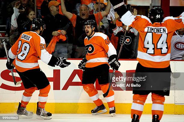 Danny Briere of the Philadelphia Flyers celebrates with teammates Claude Giroux and Kimmo Timonen after scoring a goal in the first period against...