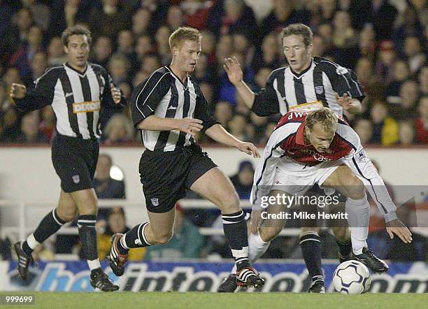 Dennis Bergkamp of Arsenal battles through the Grimsby defence during the Worthington Cup Fourth Round match between Arsenal and Grimsby Town at...