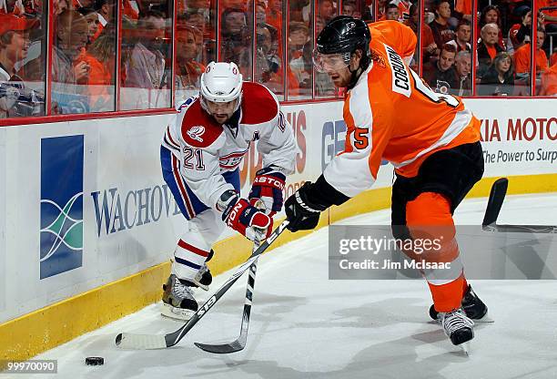 Brian Gionta of the Montreal Canadiens fights for the puck against Braydon Coburn of the Philadelphia Flyers in Game 2 of the Eastern Conference...