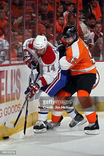 Tomas Plekanec of the Montreal Canadiens fights for the puck against Simon Gagne of the Philadelphia Flyers in Game 2 of the Eastern Conference...
