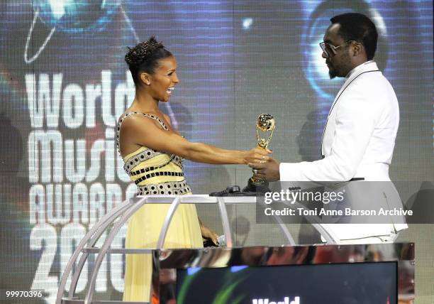 Melody Thornton and Will I.A.M speak on stage during the World Music Awards 2010 at the Sporting Club on May 18, 2010 in Monte Carlo, Monaco.