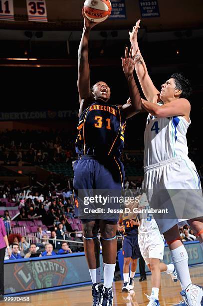 Tina Charles of the Connecticut Sun puts a shot up over Janel McCarville of the New York Liberty during the WNBA preseason game on May 11, 2010 at...