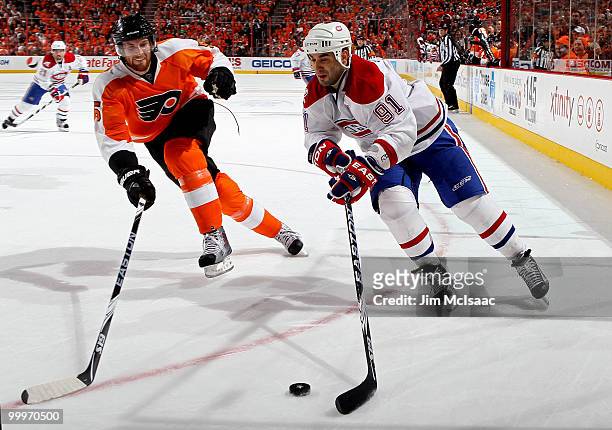 Scott Gomez of the Montreal Canadiens handles the puck against Braydon Coburn of the Philadelphia Flyers in Game 2 of the Eastern Conference Finals...