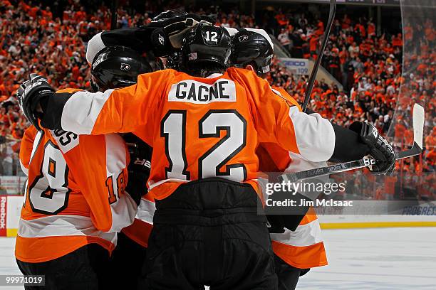 Simon Gagne of the Philadelphia Flyers celebrates with his teammates after scoring a goal in the second period against the Montreal Canadiens in Game...