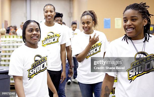 Natasha Lacy, Chante Black, Amber Holt and Shavonte Zellous of the Tulsa Shock volunteer at the Community Food Bank of Eastern Oklahoma on May 13,...