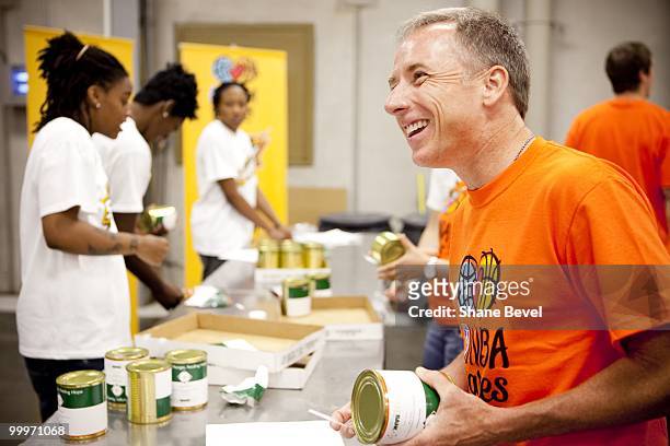 Owner David Box of the Tulsa Shock volunteers at the Community Food Bank of Eastern Oklahoma on May 13, 2010 in Tulsa, Oklahoma. NOTE TO USER: User...