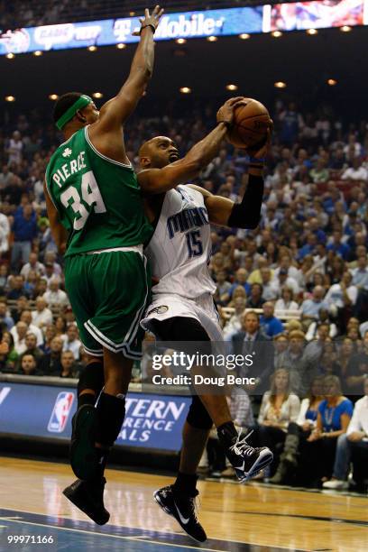 Vince Carter of the Orlando Magic drives to the basket in the first quarter against Paul Pierce of the Boston Celtics in Game Two of the Eastern...