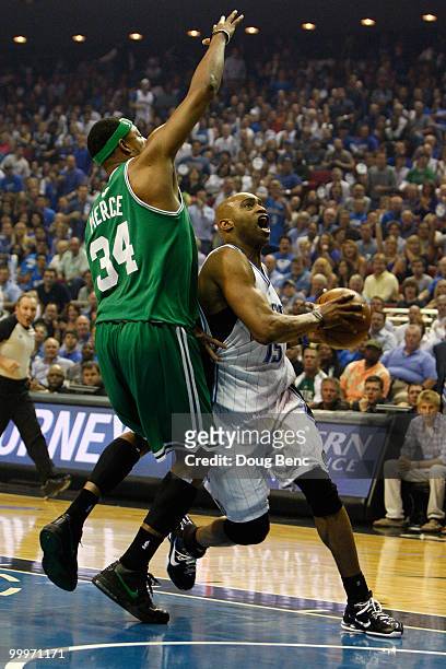 Vince Carter of the Orlando Magic drives to the basket in the first quarter against Paul Pierce of the Boston Celtics in Game Two of the Eastern...