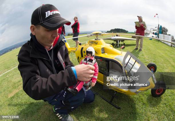 Model aircraft enthusiast Mathias Fischer holding a pilot figure for his ADAC model helicopter "Christoph 31" at the "Mega Flugshow" air show in...