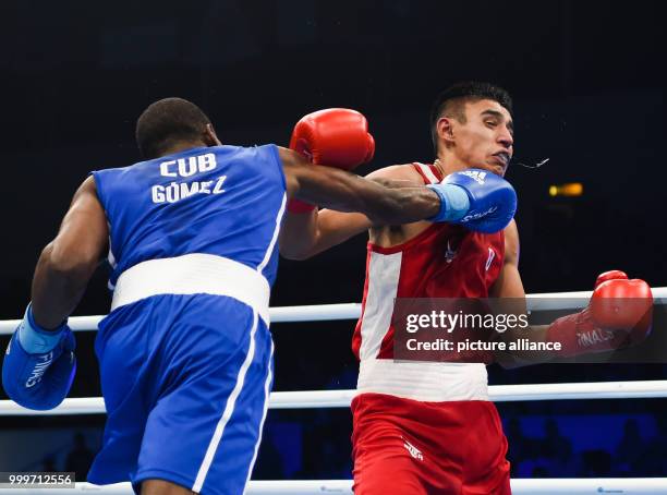 Andy Cruz Gomez of Cuba fighting Ikboljon Kholdarov of Uzbekistan in the light welterweight final bout of the AIBA World Boxing Championships in...