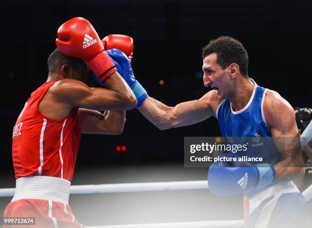 Lazaro Alvarez Estrada of Cuba fighting Sofiane Oumiha of France in the lightweight final bout of the AIBA World Boxing Championships in Hamburg,...