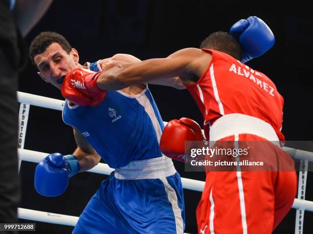 Lazaro Alvarez Estrada of Cuba fighting Sofiane Oumiha of France in the lightweight final bout of the AIBA World Boxing Championships in Hamburg,...