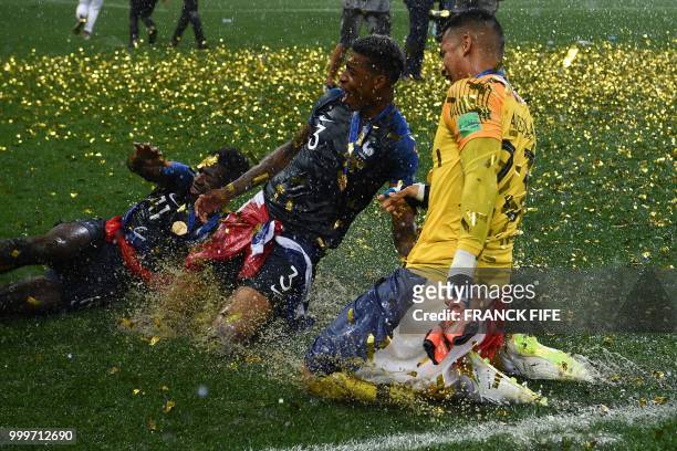 France's forward Ousmane Dembele, France's defender Presnel Kimpembe and France's goalkeeper Alphonse Areola celebrate after winning the Russia 2018...