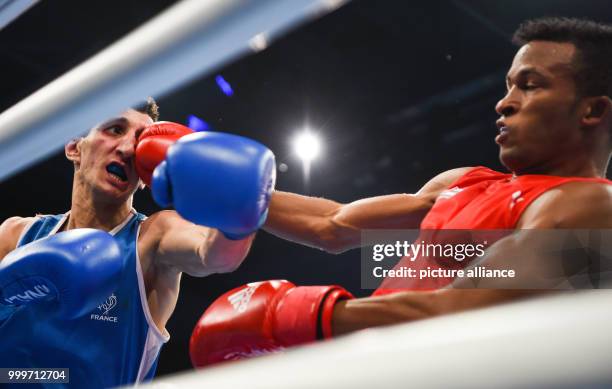 Lazaro Alvarez Estrada of Cuba fighting Sofiane Oumiha of France in the lightweight final bout of the AIBA World Boxing Championships in Hamburg,...