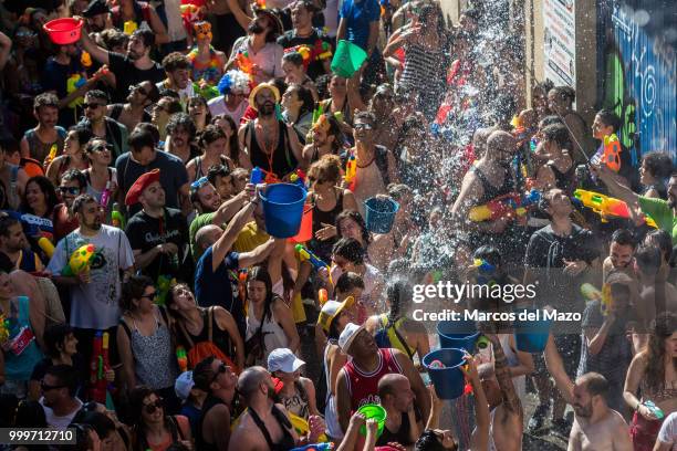 Revelers take part in the annual water fight known as "Batalla Naval" in Vallecas neighborhood, where thousands of people gathered to play with water.