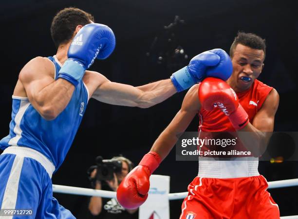 Lazaro Alvarez Estrada of Cuba fighting Sofiane Oumiha of France in the lightweight final bout of the AIBA World Boxing Championships in Hamburg,...