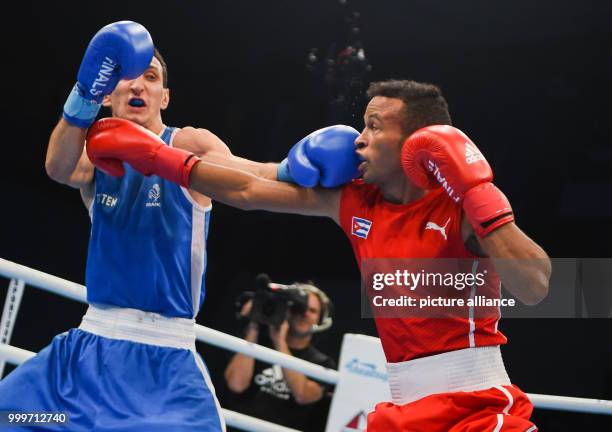 Lazaro Alvarez Estrada of Cuba fighting Sofiane Oumiha of France in the lightweight final bout of the AIBA World Boxing Championships in Hamburg,...