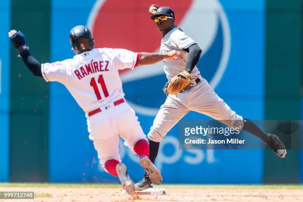Shortstop Didi Gregorius of the New York Yankees throws out Yonder Alonso of the Cleveland Indians at first as Jose Ramirez is out at second for a...