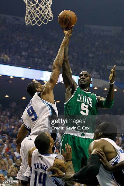 Kevin Garnett of the Boston Celtics attempts a shot against Rashard Lewis of the Orlando Magic in Game Two of the Eastern Conference Finals during...