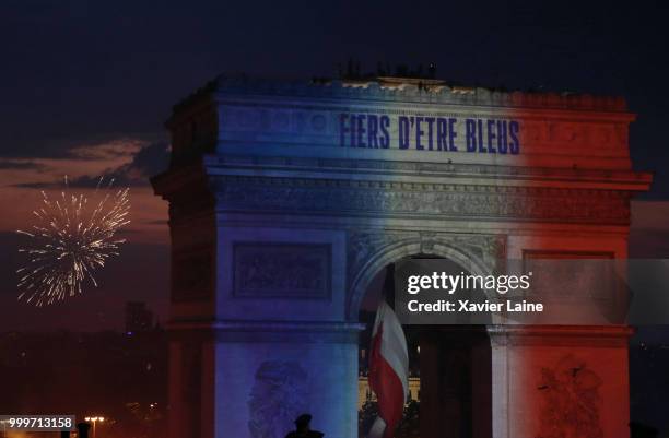 Fiers D'etre Bleus in reference to the French national team's nickname Les Bleus is projected onto the Arc de Triomphe as fans celebrate France’s...