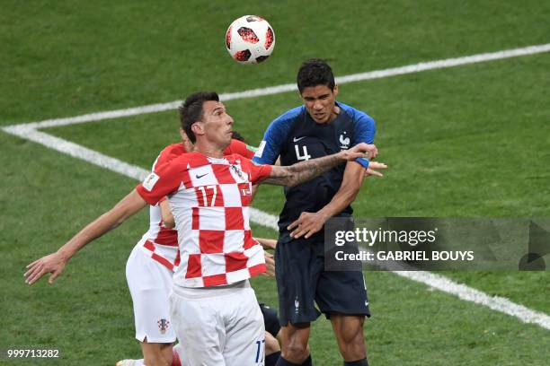 Croatia's forward Mario Mandzukic fights for the ball with France's defender Raphael Varane during the Russia 2018 World Cup final football match...