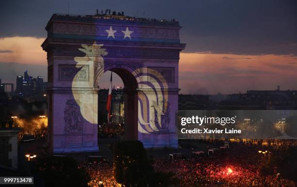 The symbol of the French national team is projected onto the Arc de Triomphe as fans celebrate France’s victory over Croatia in the 2018 FIFA World...