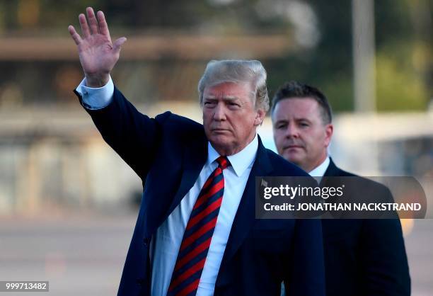 President Donald Trump waves upon arrival at Helsinki-Vantaa Airport in Helsinki, on July 15, 2018 on the eve of a summit in Helsinki between the US...