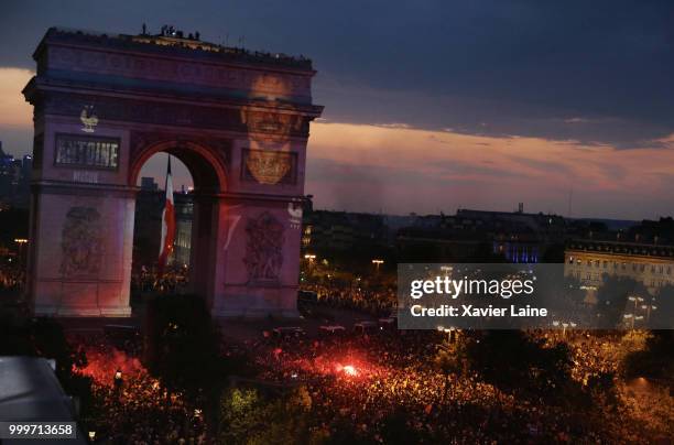 Antoine Griezmann is projected on the Arc de Triomphe des champs elysee as fans celebrate France’s victory over Croatia in the 2018 FIFA World Cup...